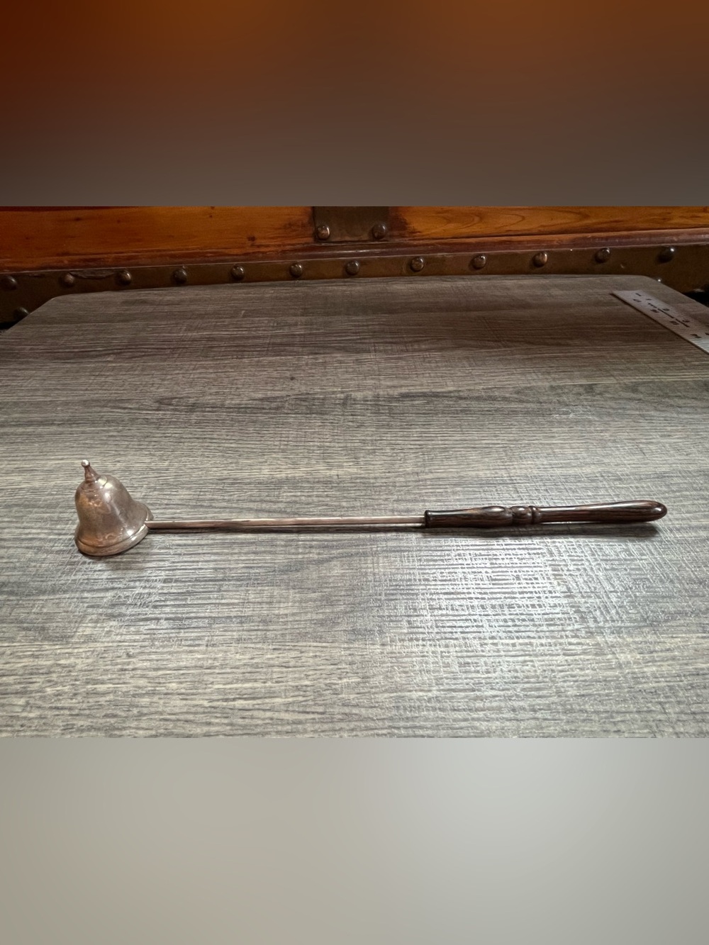 Sterling silver candle snuffer with wooden handle. Light. Needs polished.
